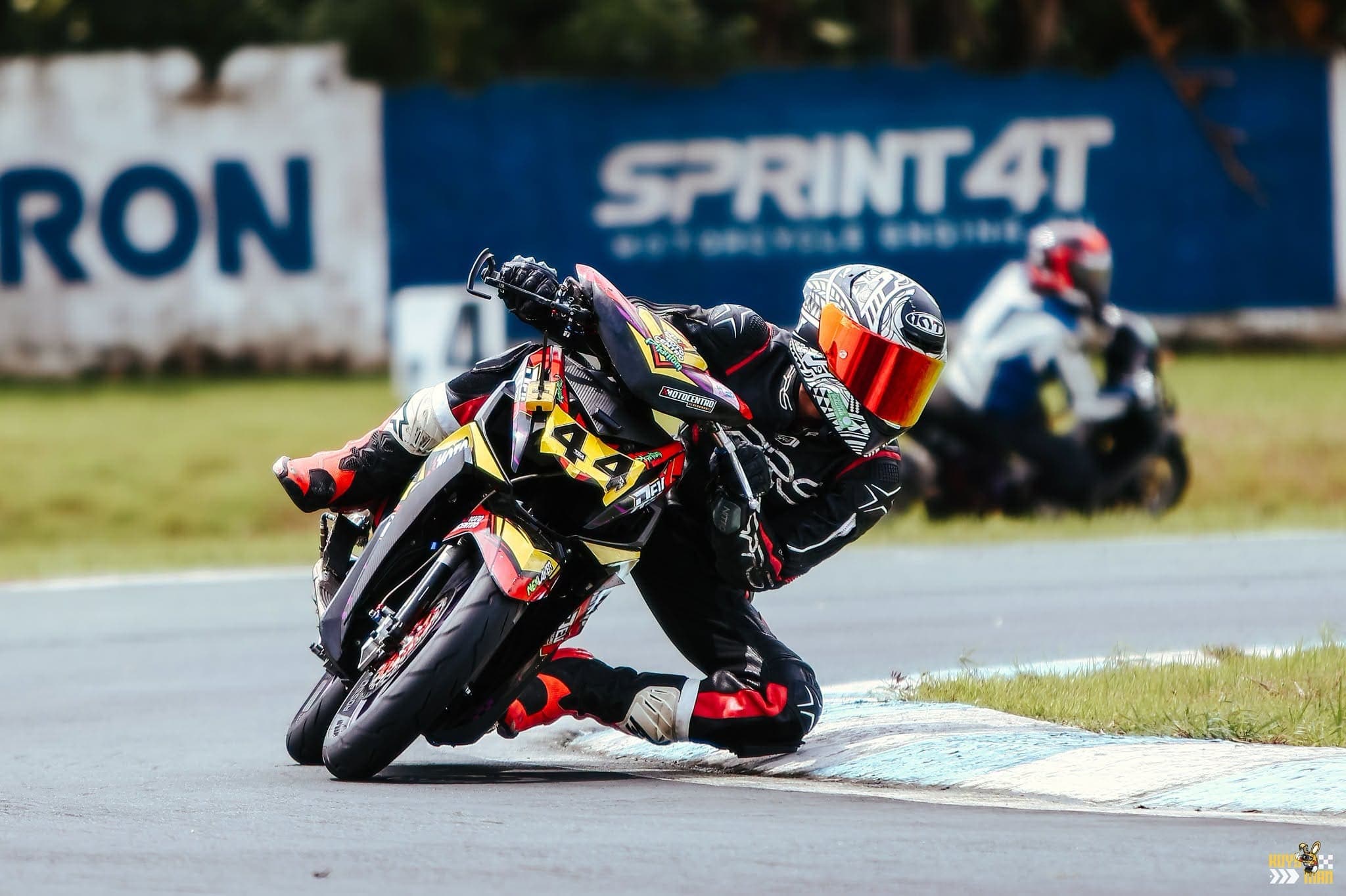 The number 44 machine knee-down through a corner with another rider behind